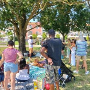 Image of participants sharing food and chatting during the picnic.
