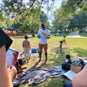 Image of participants sharing food and chatting during the picnic.