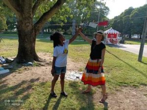 Close-up of a participant showing their personal photograph from a trip around Europe